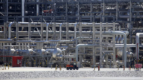 FILE PHOTO: A small vehicle drives past a network of piping that makes up pieces of a "train" at the Cameron LNG export facility in Hackberry, Louisiana.