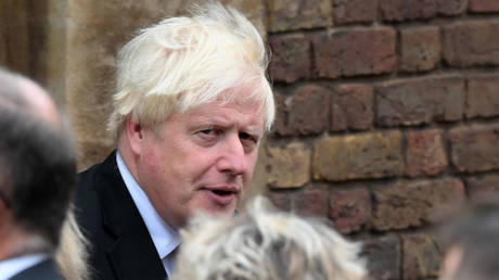 Ex-Prime Minister Boris Johnson is shown leaving a ceremony last month in London to proclaim King Charles III as the UK's new monarch.