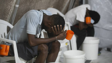 FILE PHOTO: Patients with cholera symptoms sit in an observation center at a cholera clinic run by Doctors Without Borders in Port-au-Prince, Haiti, October 7, 2022.