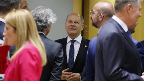 German chancellor Olaf Scholz and European Council president Charles Michel speak ahead of a EU leaders summit in Brussels.