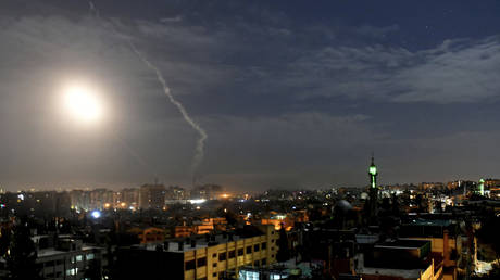 FILE PHOTO: Missiles are seen flying over Damascus, Syria during an Israeli air raid, January 21, 2019.