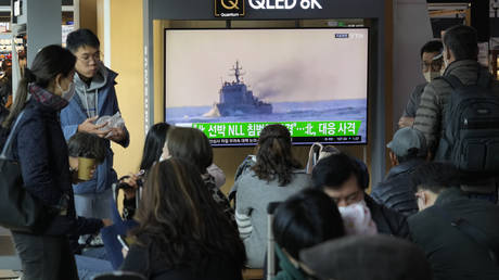 A TV screen shows a file image of a South Korean navy vessel during a news program at the Seoul Railway Station in Seoul, South Korea.