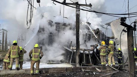 Ukrainian firefighters extinguishing a fire at an energy infrastructure damaged by a missile strike in Rivne region.