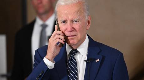 FILE PHOTO: Joe Biden speaks on the phone during an Oregon Democrats event at in Portland, Oregon, October 14, 2022