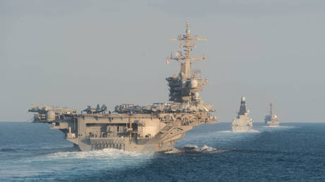 FILE PHOTO: The USS Abraham Lincoln is shown passing through the Strait of Hormuz in November 2019.