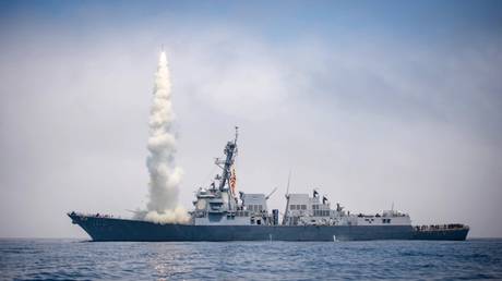 FILE PHOTO: A US guided-missile destroyer conducts a Tomahawk cruise missile flight test while underway in the western Pacific Ocean.