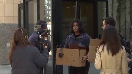 Two pranksters posing as Twitter employees are interviewed by reporters outside Twitter’s headquarters in San Francisco, California, October 28, 2022.