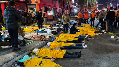 Bodies of victims, believed to have suffered cardiac arrest, are covered in the popular nightlife district of Itaewon in Seoul.