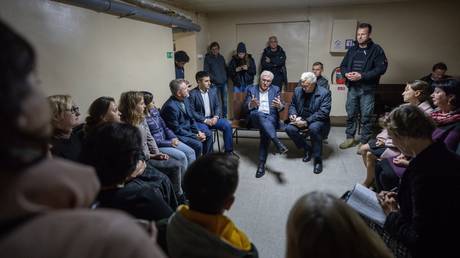 German President Frank-Walter Steinmeier (M) waits in the air-raid shelter after an air-raid alert and talks to residents of the city and listens to their experiences.