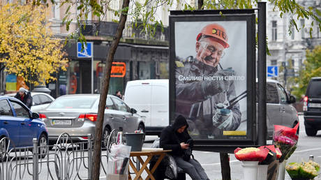 A sign in Kiev depicting a worker of the Ukrainian energy company DTEK, reading 'To carry the light bravely', October 24, 2022.