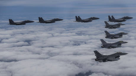 South Korean F-15K and US F-16 fighter jets fly in formation during a joint drill in an undisclosed location in South Korea, October 4, 2022.