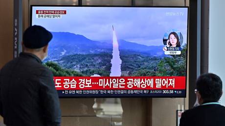 FILE PHOTO. People watch a news broadcast with file footage of a North Korean missile test, at a railway station in Seoul, South Korea.