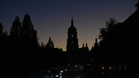 Vehicles in near darkness in central Kiev with the iconic St. Sophia Cathedral silhouetted in the background following a Russian aerial attack on October 31, 2022, Kiev, Ukraine