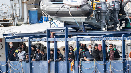 People onboard the Humanity 1 in the port of Catania, Sicily.