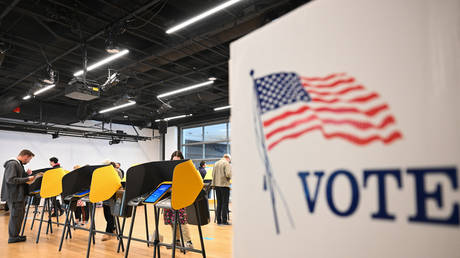 People cast ballots on electronic voting machines for the midterm election during early voting ahead of Election Day inside a vote center at the Hammer Museum in Los Angeles, California on November 7, 2022.