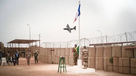 The French flag is replaced with that of Mali in an official ceremony transferring ownership of the Barkhane camp in Timbuktu last year