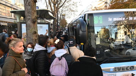 Commuters get into a bus near the Gare Montparnasse railway station during a strike in Paris.