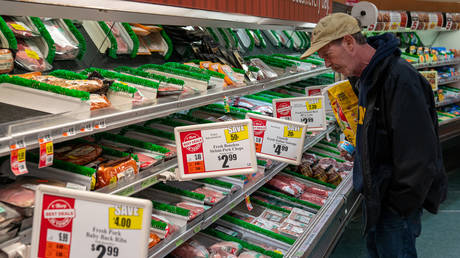 A man looks over the meat selection at a Tops Super Market October 27, 2022 in Greenville, New York.