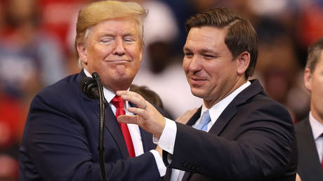 FILE PHOTO: Then-President Donald Trump and Florida Governor Ron DeSantis are shown at a November 2019 campaign rally in Sunrise, Florida.