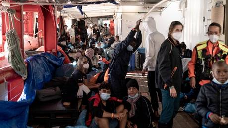 Migrants stand on board the Ocean Viking prior disembarking, in Toulon.