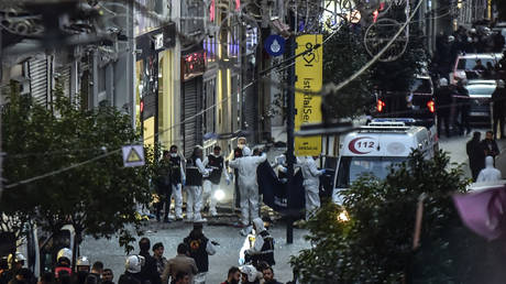 Forensic experts collect a dead body after an explosion on Istanbul's popular pedestrian Istiklal Avenue Sunday, on November 13, 2022.