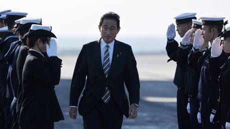 Japanese Prime Minister Fumio Kishida is shown visiting members of the Maritime Self-Defense Force last week on Yokosuka, Japan.