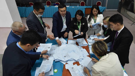Members of a local electoral commission count ballots at a polling station after Kazakhstan's presidential elections in Astana on November 20, 2022.