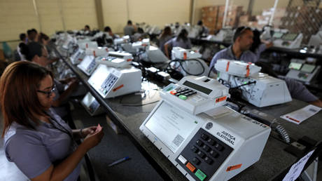 FILE PHOTO: Electoral Court employees work on the final stage of sealing electronic voting machines in preparation for the general election run-off in Brasilia, Brazil, October 19, 2022