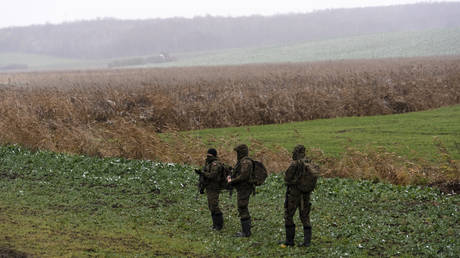 Polish soldiers search for missile wreckage in a field near where a missile struck at Przewodow, Poland, November 17, 2022