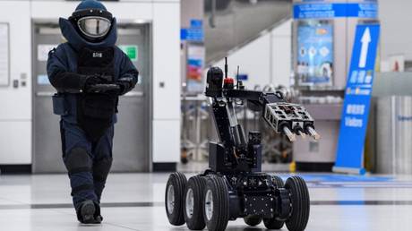 FILE PHOTO: A Hong Kong Police officer controls a bomb disposal robot during a counter-terrorism exercise at the Lok Ma Chau Spur Line Control Point in Hong Kong, March 20, 2020.