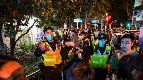 Police officers disperse a protest in Shanghai, China, November 27, 2022