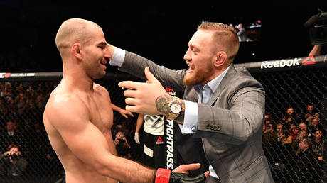 Artem Lobov of Russia celebrates with teammate and UFC champion Conor McGregor after his featherweight bout against Teruto Ishihara
