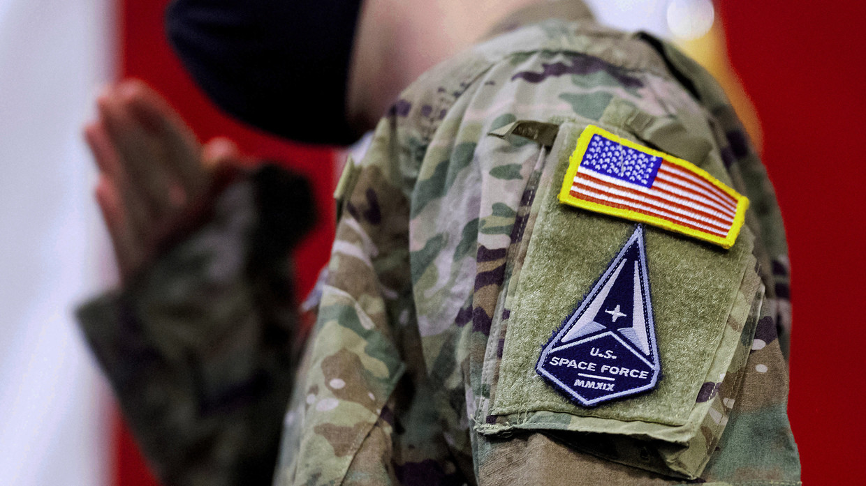 FILE PHOTO: A US soldier salutes during a ceremony for airmen transitioning into the Space Force, at Travis Air Force Base, California.