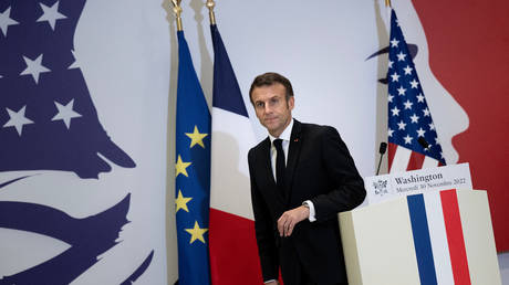 French President Emmanuel Macron stands at a podium at the French embassy in Washington, DC, on November 30, 2022.