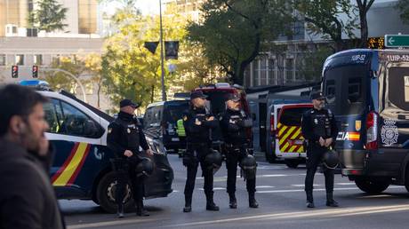 Several National Police officers in the vicinity of the US Embassy in Madrid where a parcel bomb has been received, December 1, 2022, in Madrid, Spain.