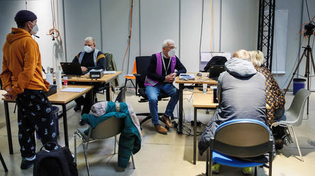 FILE PHOTO: Employees record the data of refugees upon arrival at the Ukraine Arrival Center Tegel, Germany