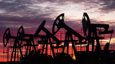 FILE PHOTO. Oil pumping jacks in an oil field at sunset in Russia
