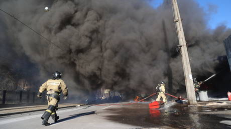 Firefighters at work after Kiev’s forces shelled the center of Donetsk, Russia