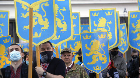 Ukrainian nationalists carry emblems of the SS Galicia Division during a commemorative march in Kiev, Ukraine, on April 28, 2021.
