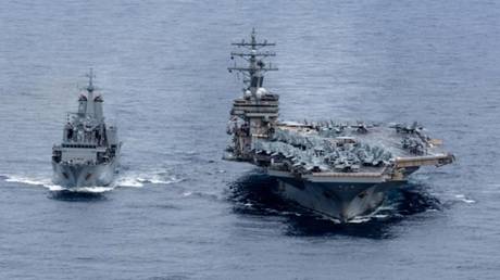 FILE PHOTO: The USS Ronald Reagan, a US aircraft carrier, conducts a joint mission with a Royal Australian Navy supply ship in the Philippine Sea, November 20, 2022.