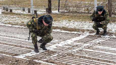 FILE PHOTO. Belarusian border patrol guards train to identify footprints.