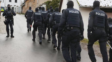Police are shown securing the area around the Waidmannsheil hunting lodge in Thuringia state, where a coup attempt against German Chancellor Olaf Scholz was allegedly plotted.