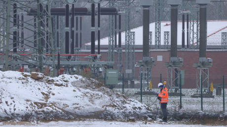 A worker stands outside an electricity substation last month on the outskirts of Berlin.