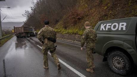 NATO soldiers from the KFOR peacekeeping mission inspect a barricade set up by ethnic Serbs near Zubin Potok, December 11, 2022.