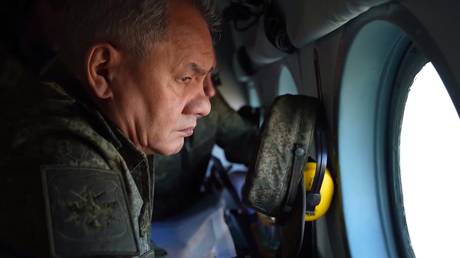 Defense Minister Sergey Shoigu flies above Russian position on a helicopter.