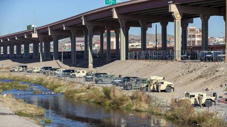 Texas National Guards line up their armored vehicles in the northern bank of the Rio Grande to prevent migrants from approaching the border fence in their attempt to enter into El Paso, Texas from Ciudad Juarez, Mexico, December 21, 2022