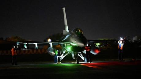 Taiwanese Air Force staffs inspect a US-made F-16V fighter jet during a drills.