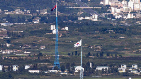 FILE PHOTO: The flags of North Korea and South Korea are seen near the border area between the two countries, in Paju, South Korea, August 9, 2021.