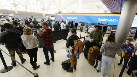 Travelers queue at the Southwest Airlines check-in counter in Denver International Airport in Colorado, December 27, 2022