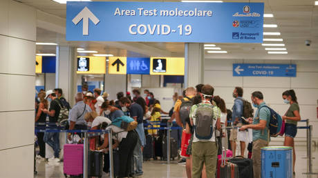 FILE PHOTO: Vacationers line up to be tested for Covid-19 upon arrival at Leonardo Da Vinci Airport in Rome, Italy, August 16, 2020